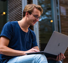 A University of Bridgeport online student using a laptop