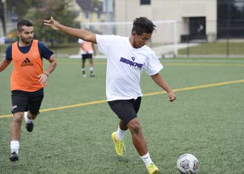 UB soccer player kicking the ball