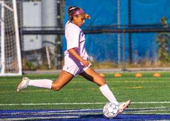 UB soccer player kicking the ball