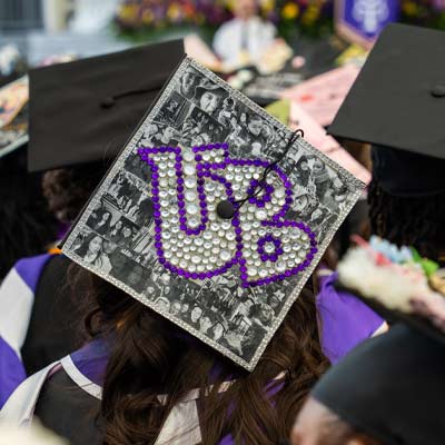 mortar board decorated with UB spelled out in rhinestones
