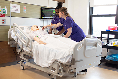 2 UB RN Students in the Sim Lab