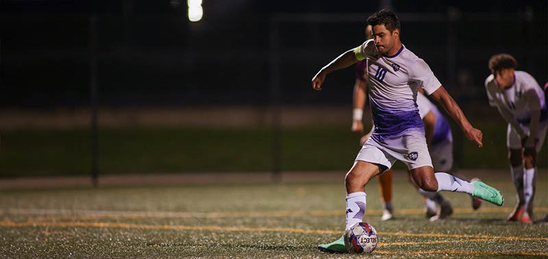 soccer player kicking the ball