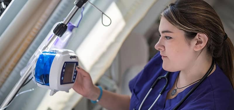 nurse looking at a monitor