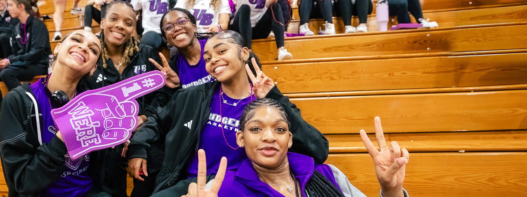 students giving peace sign at pep rally